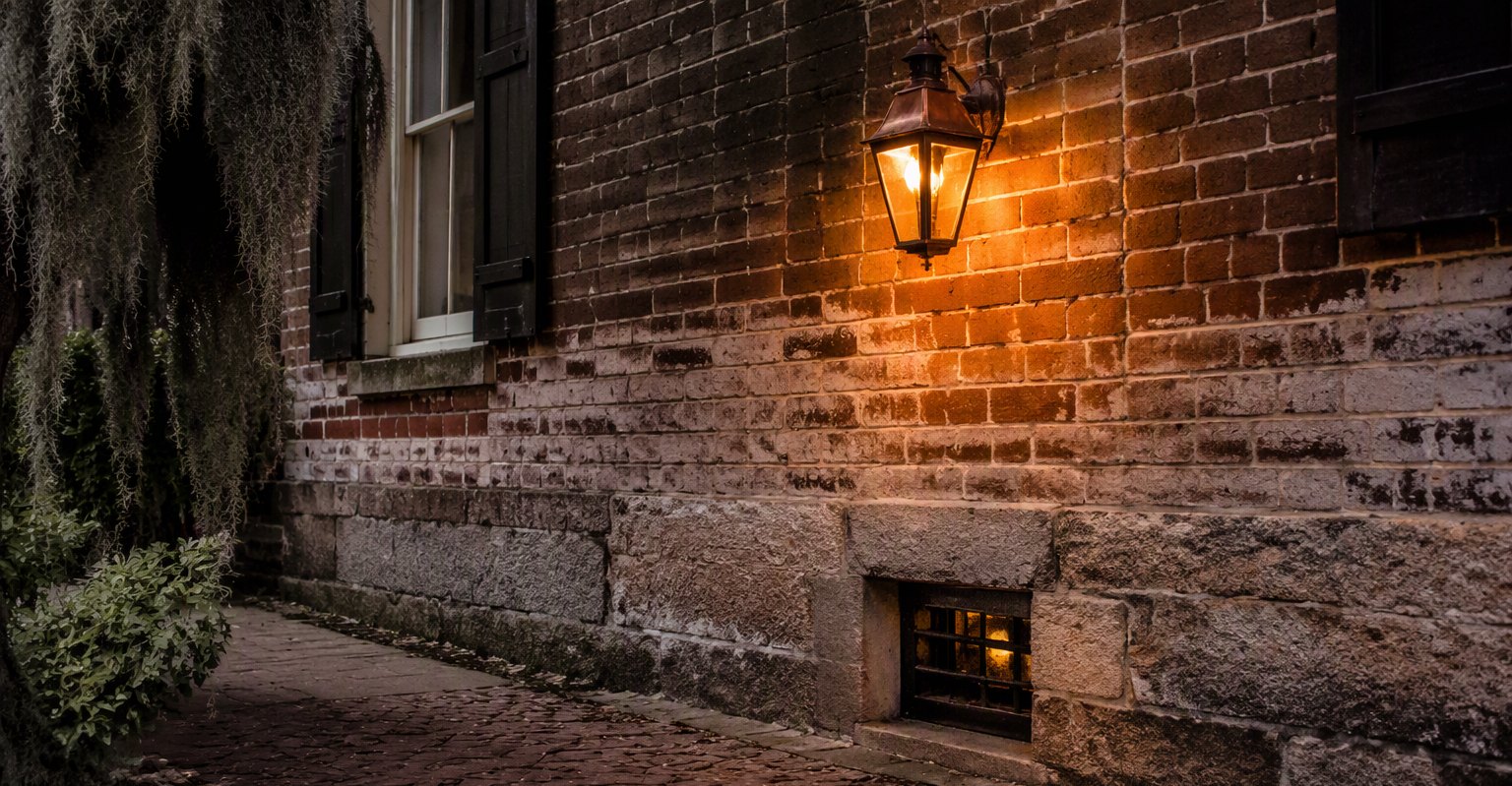 Historic brick foundation with glowing gas lantern